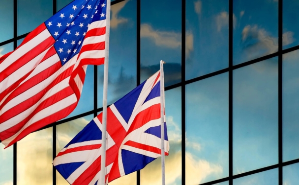 The United States and United Kingdom flags in the wind.